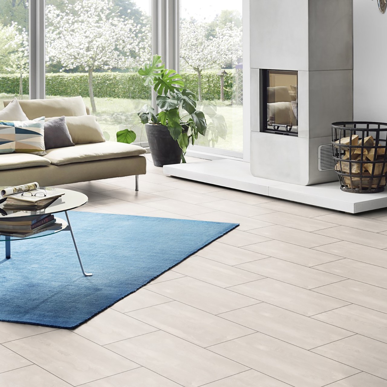 Bright and spacious living room featuring K385 Ice Flow laminate flooring that imates real tiles. Stain-resistant flooring