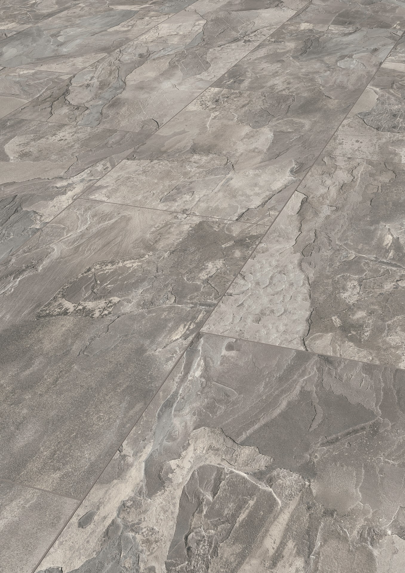 K387 Silverado Slate laminate flooring stands out with its soft and dark grey nuances and the ostensible rough emboss of the stone. 