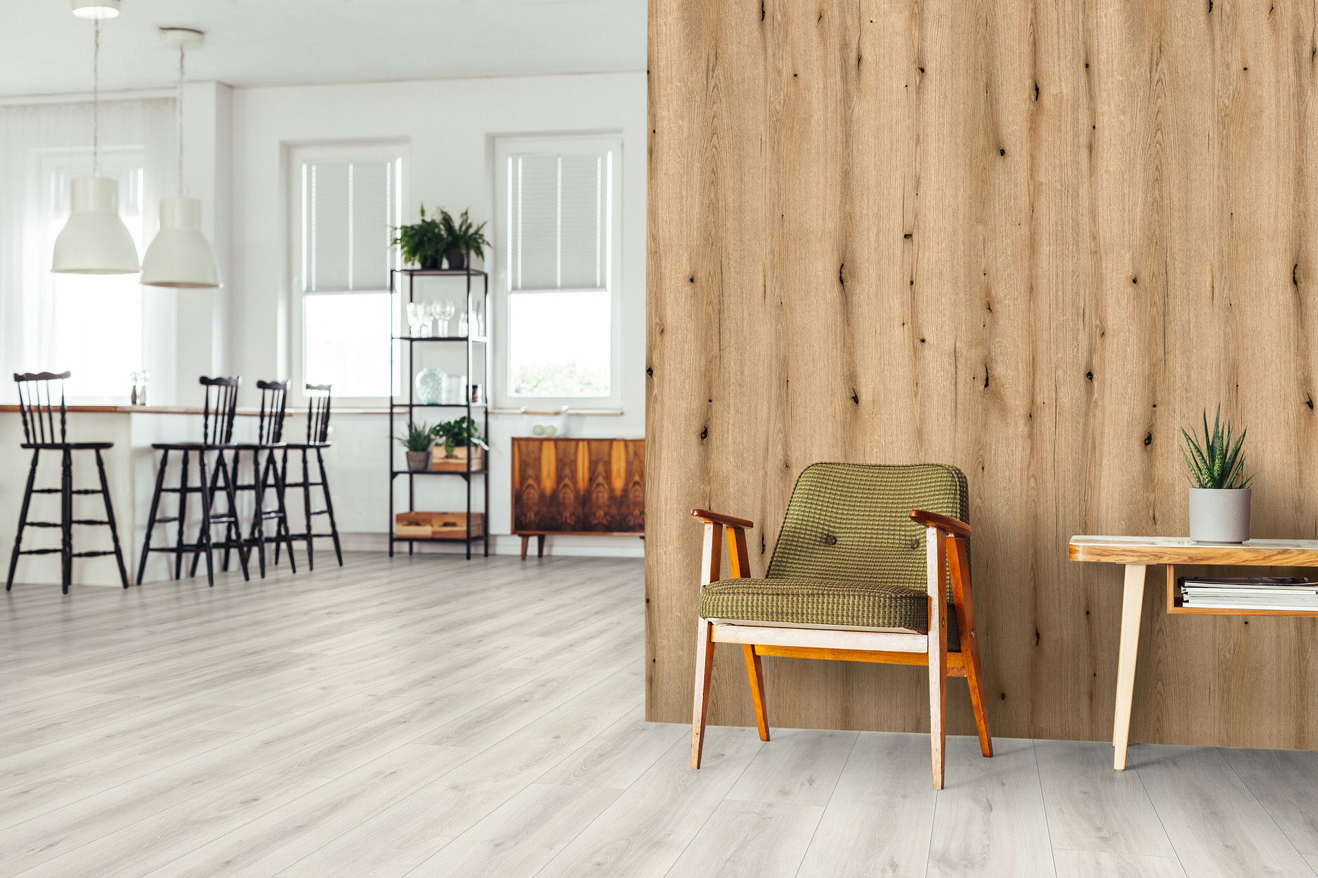Coast Evoke Oak wall panel from Rocko Tiles collection as accent behind sofa in open living space with kitchen