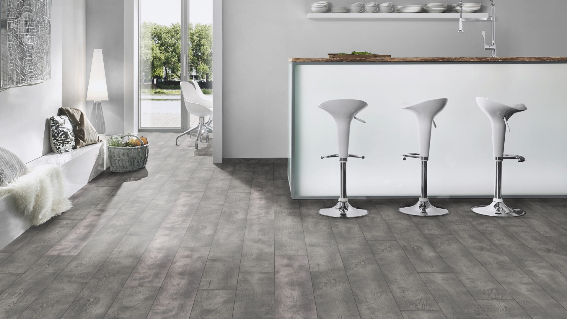 K407 Ashenwood Oak laminate flooring in kitchen interior with white breakfast bar – warm tones balancing modern design