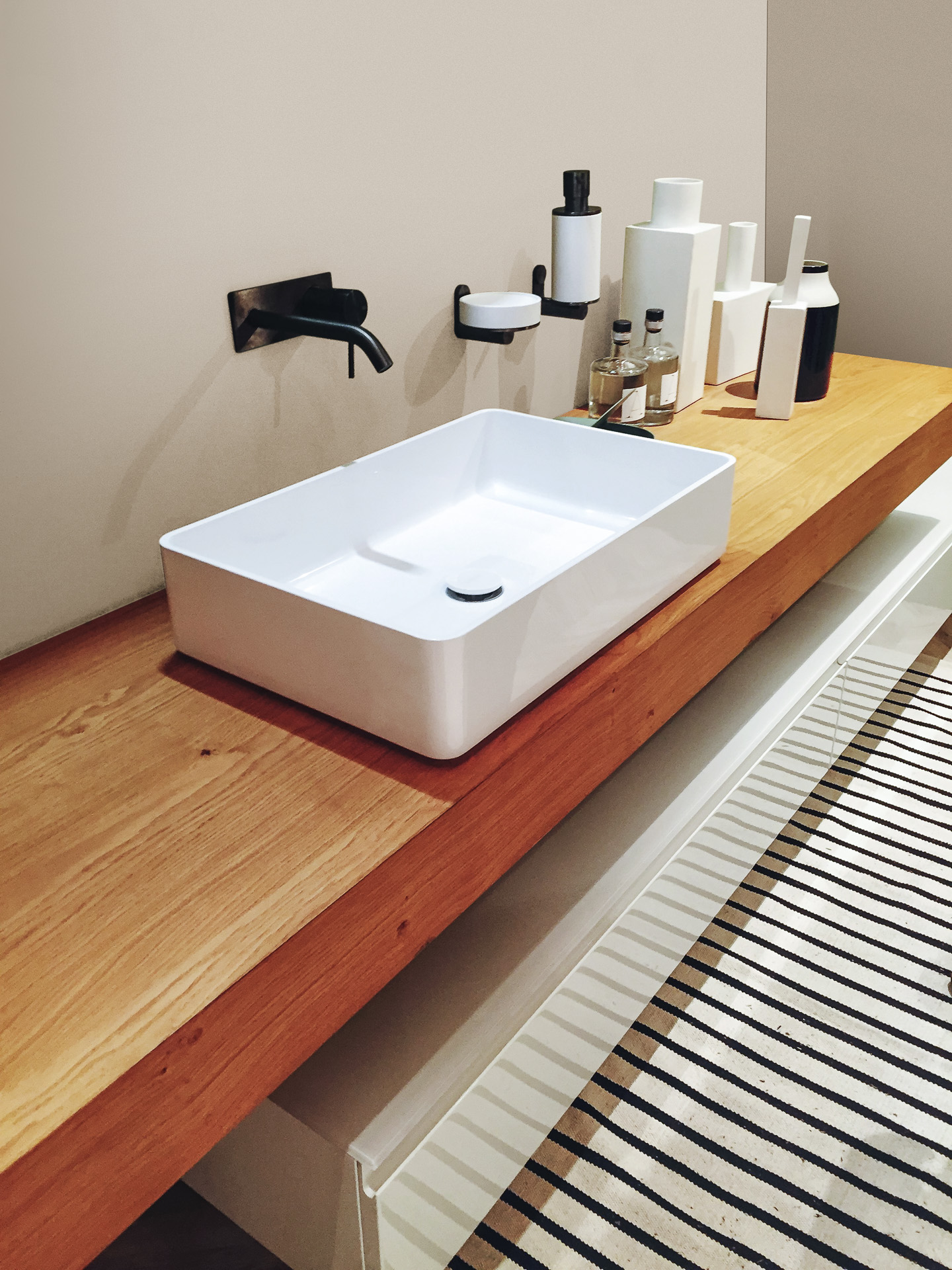 5981 Cashmere wall panel from Rocko Tiles in bathroom – elegant neutral background behind sink and wooden cabinets