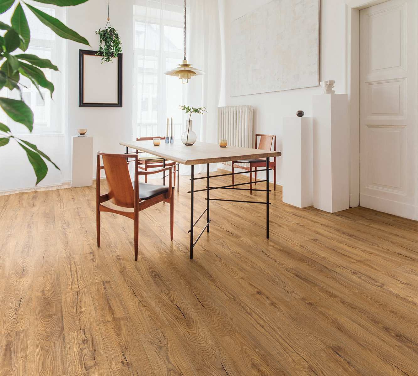 Inca Carpenter Oak 12 mm laminate flooring in elegant dining room with white and oak decor – perfect harmony of rustic and modern