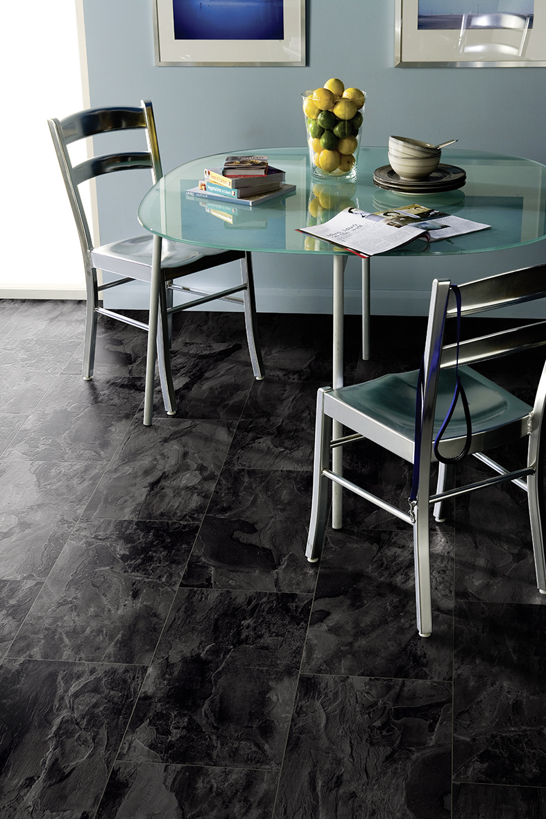 Nightfall Slate laminate in a dining setup – sleek tile-format flooring adding contrast and sophistication